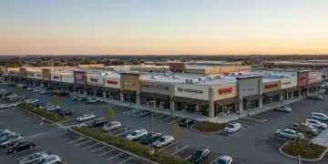 Modern retail shopping center with diverse stores and busy parking lot